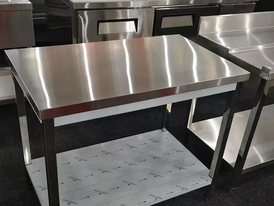Cropped photograph of a stainless worktable and undershelf at a manufacturing partner's product display