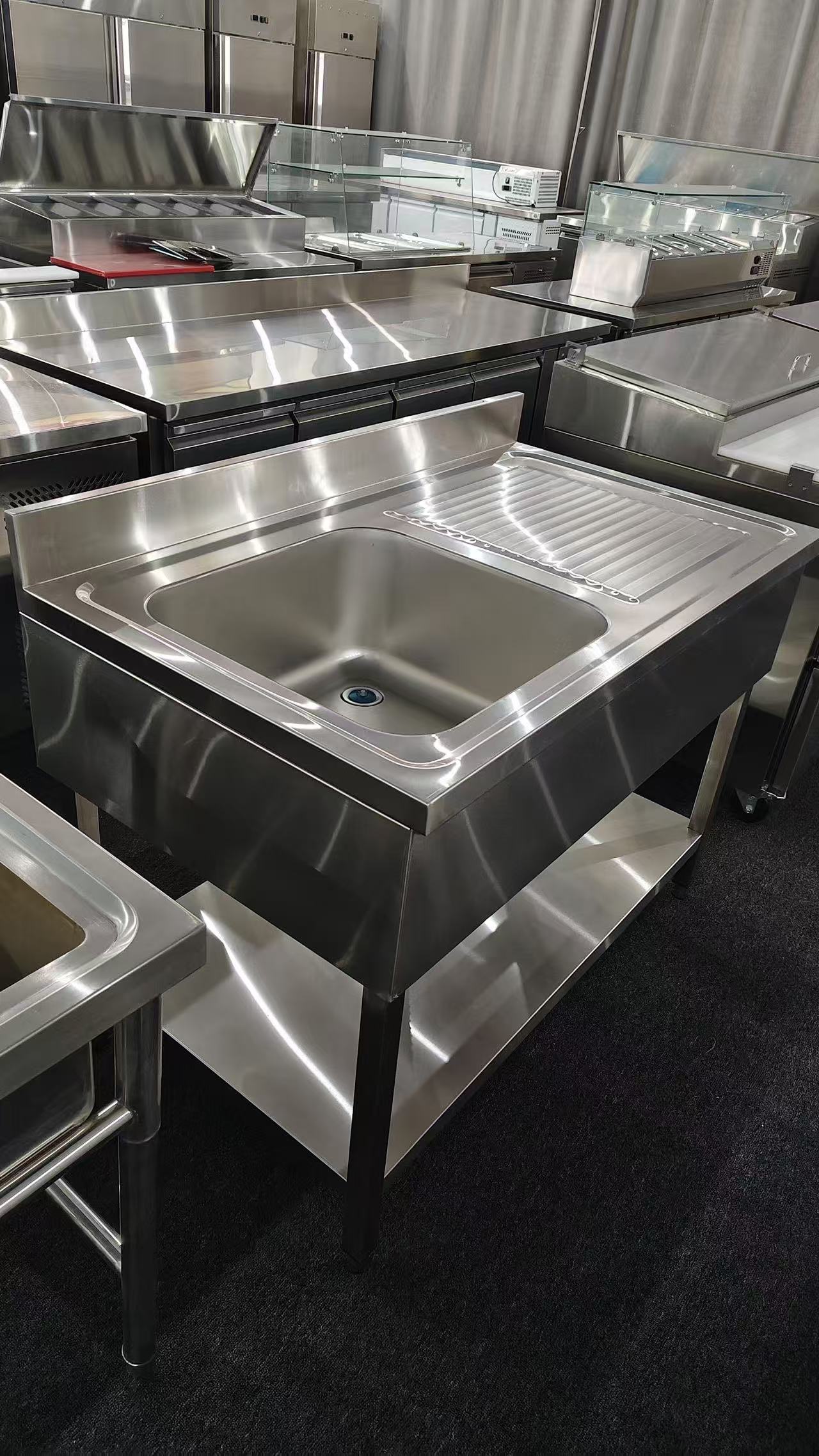 Stainless steel sink bench with bowl and drainboard photographed for interface reference