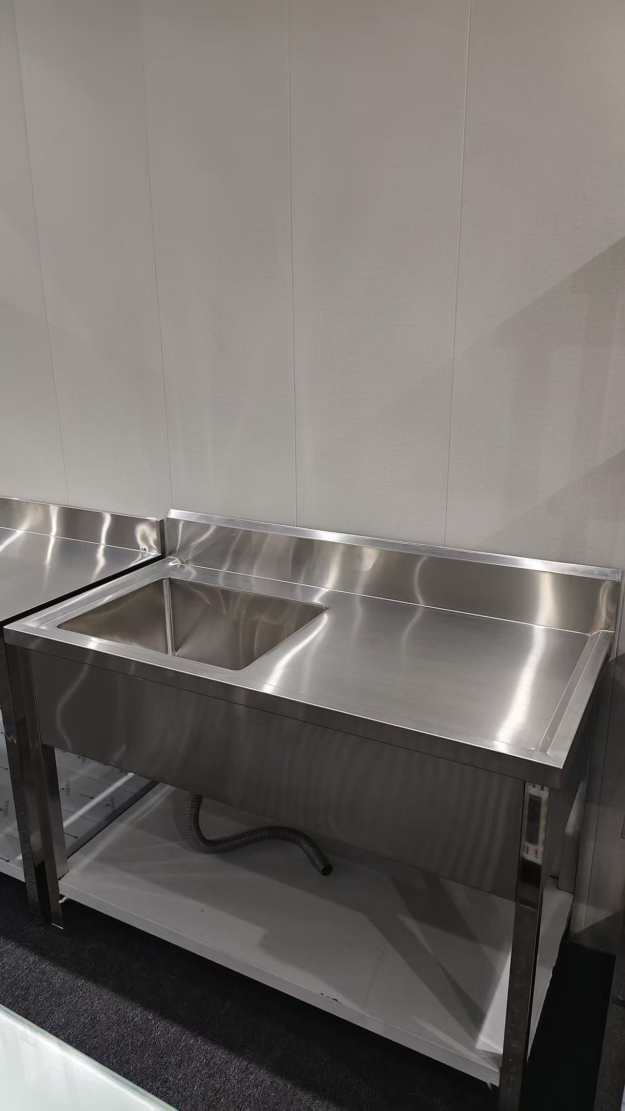 Stainless steel sink bench photographed for fitout and plumbing boundary reference