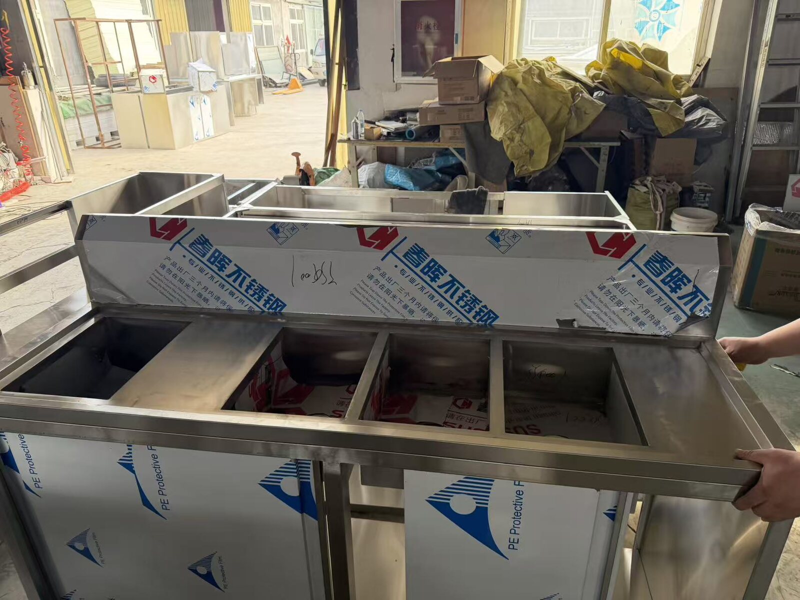 Compartment cabinet assembly in a manufacturing-partner workshop